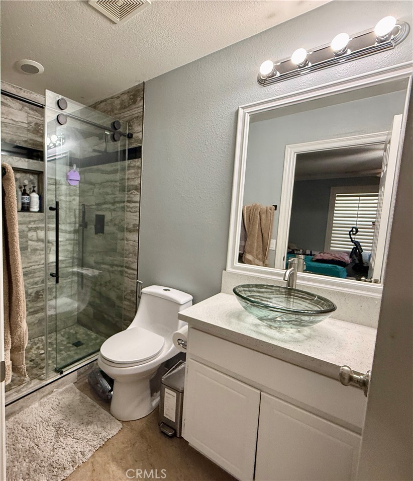 33467 Pitman Lane Menifee, CA 92584 - Photo 34 of 40 a bathroom with a sink a toilet and shower