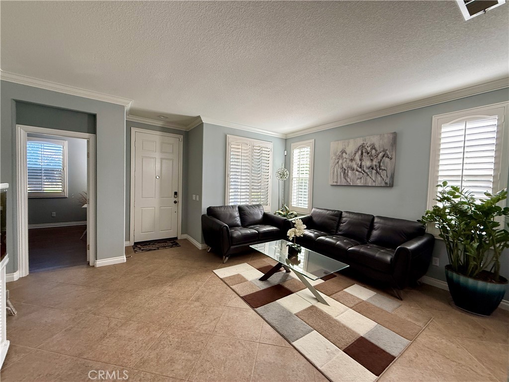 33467 Pitman Lane Menifee, CA 92584 - Photo 6 of 40 a living room with furniture potted plant and a window