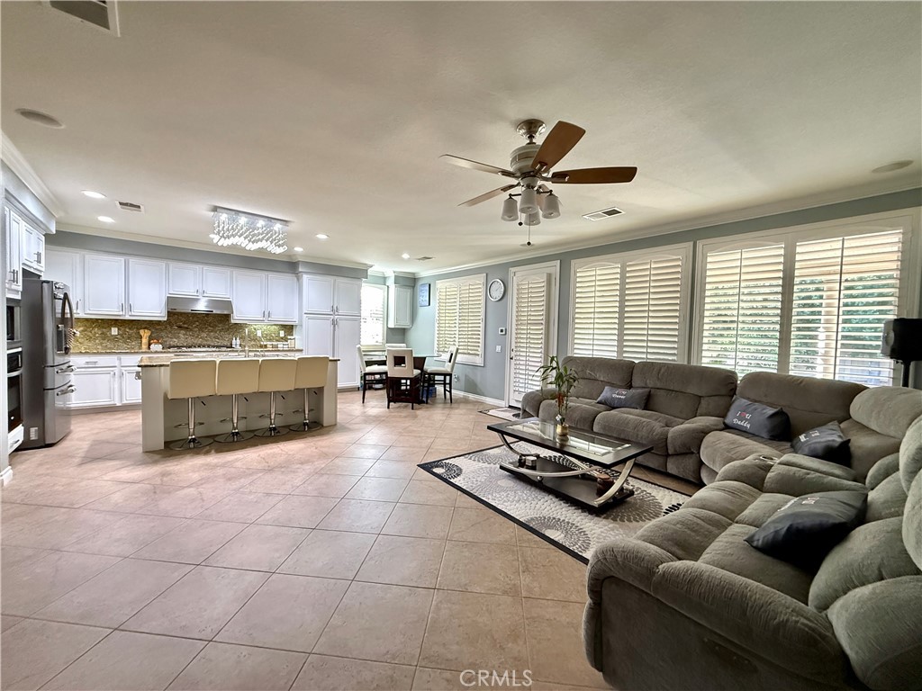 33467 Pitman Lane Menifee, CA 92584 - Photo 9 of 40 a living room with furniture kitchen view and a large window