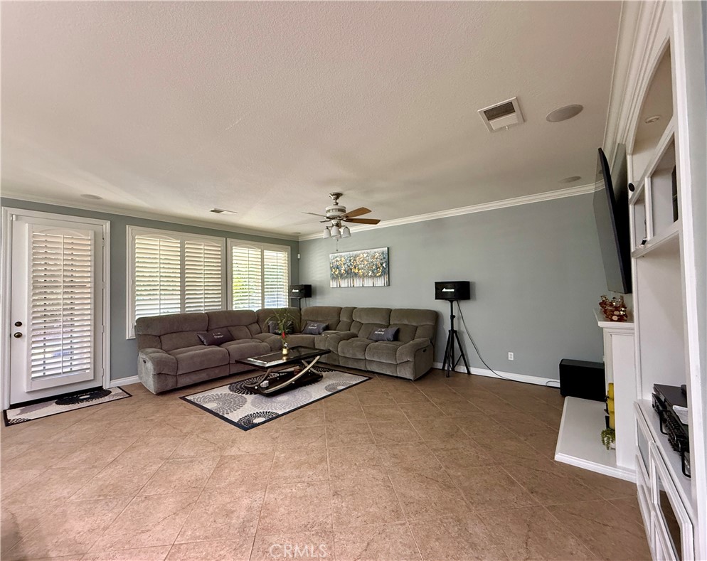 33467 Pitman Lane Menifee, CA 92584 - Photo 10 of 40 a living room with furniture and a flat screen tv