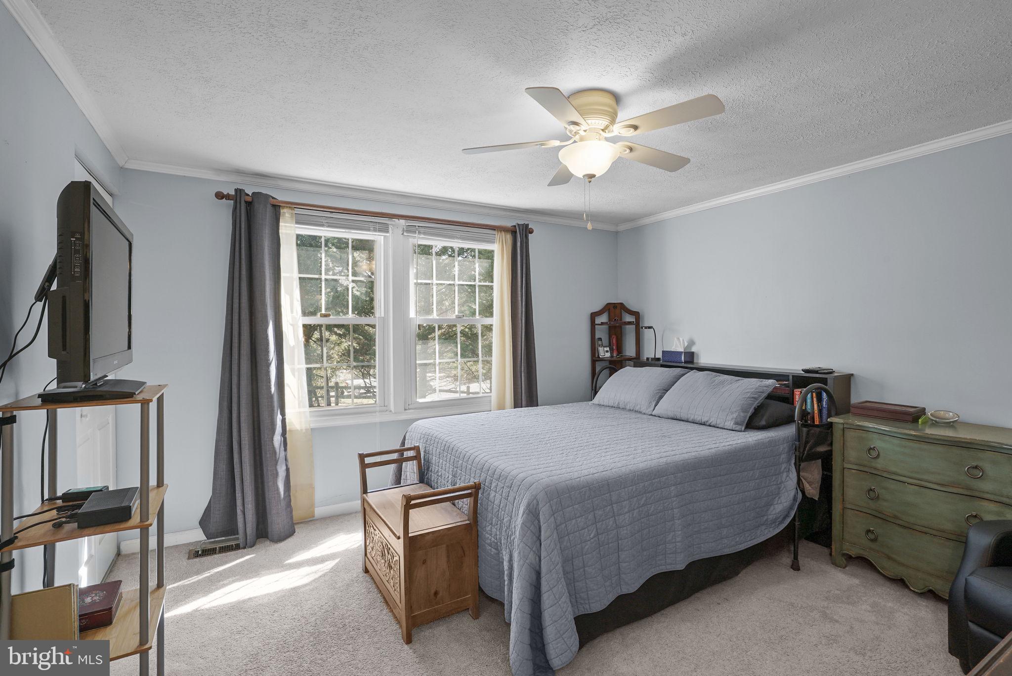 7129 Banjo Court Columbia, MD 21045 - Photo 11 of 46 a bedroom with a bed and a chandelier