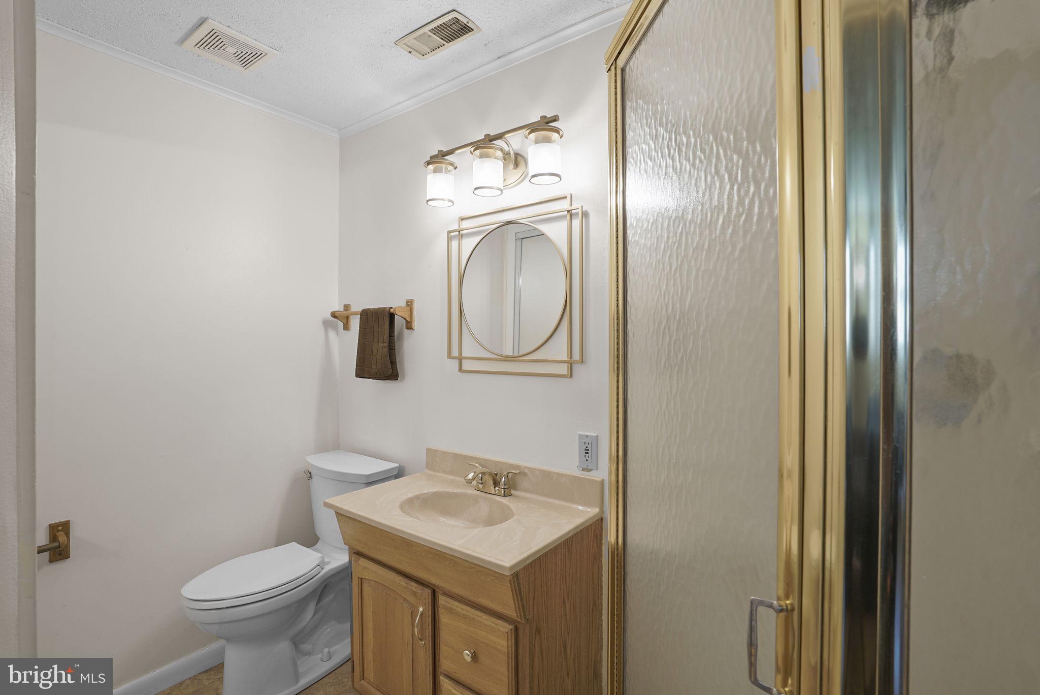7129 Banjo Court Columbia, MD 21045 - Photo 17 of 46 a bathroom with a toilet sink vanity and mirror