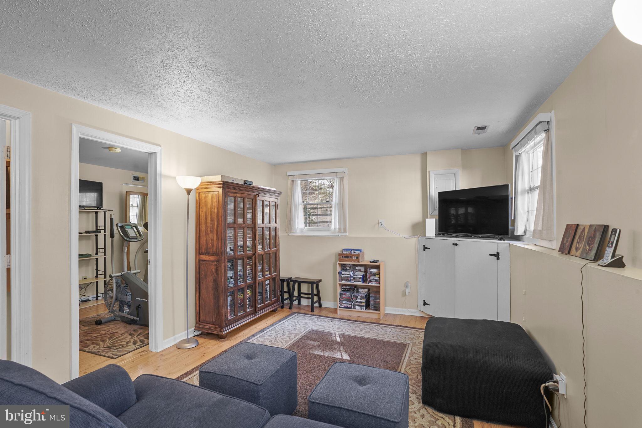 7129 Banjo Court Columbia, MD 21045 - Photo 20 of 46 a living room with furniture and a flat screen tv