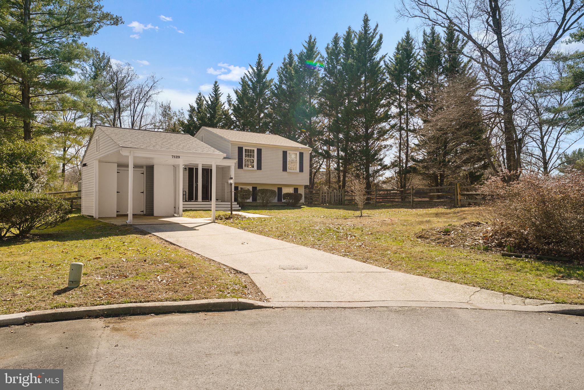 7129 Banjo Court Columbia, MD 21045 - Photo 30 of 46 a front view of a house with a yard and garage