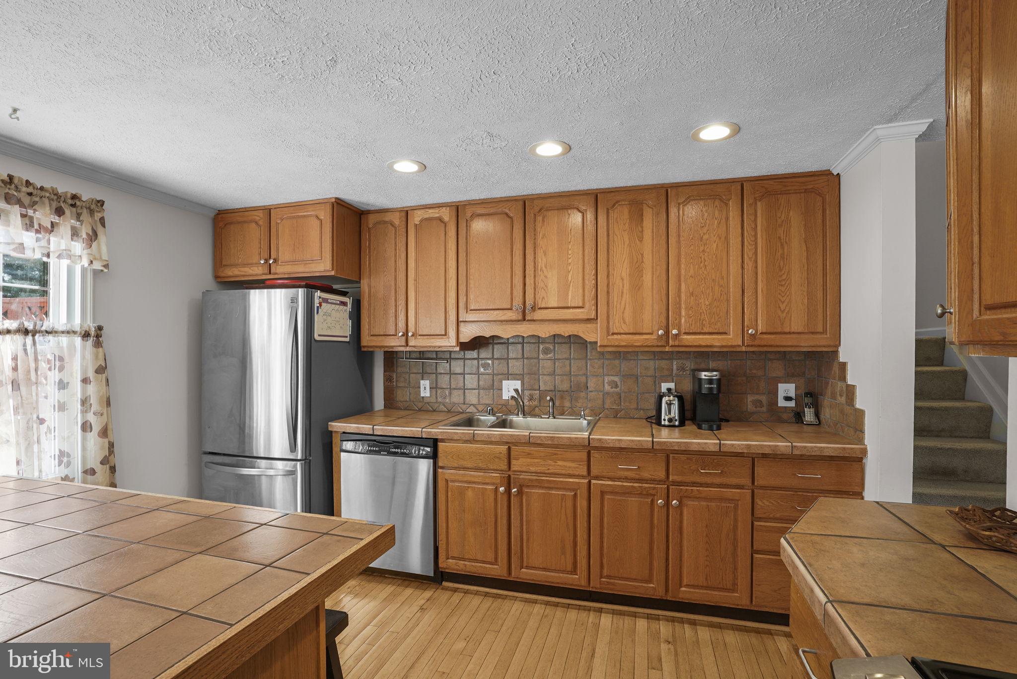7129 Banjo Court Columbia, MD 21045 - Photo 5 of 46 a kitchen with stainless steel appliances granite countertop a refrigerator sink and cabinets