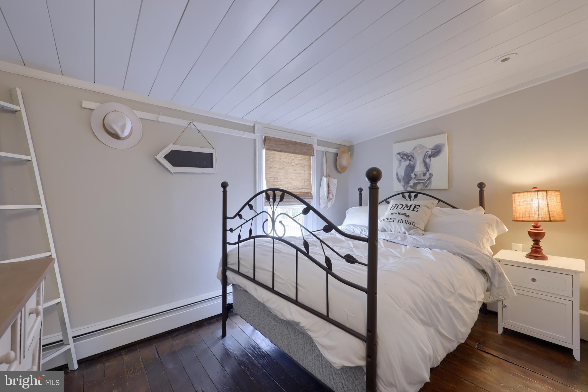 119 South Cedar Street Lititz, PA 17543 - Photo 14 of 22 a spacious bedroom with a bed and a chandelier