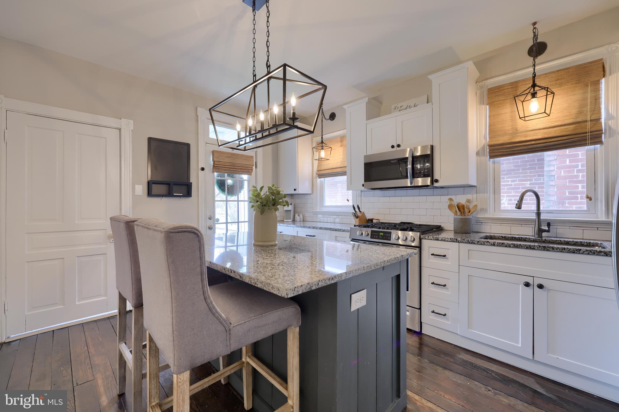 119 South Cedar Street Lititz, PA 17543 - Photo 8 of 22 a kitchen with stainless steel appliances granite countertop a stove top oven a sink a counter space and cabinets