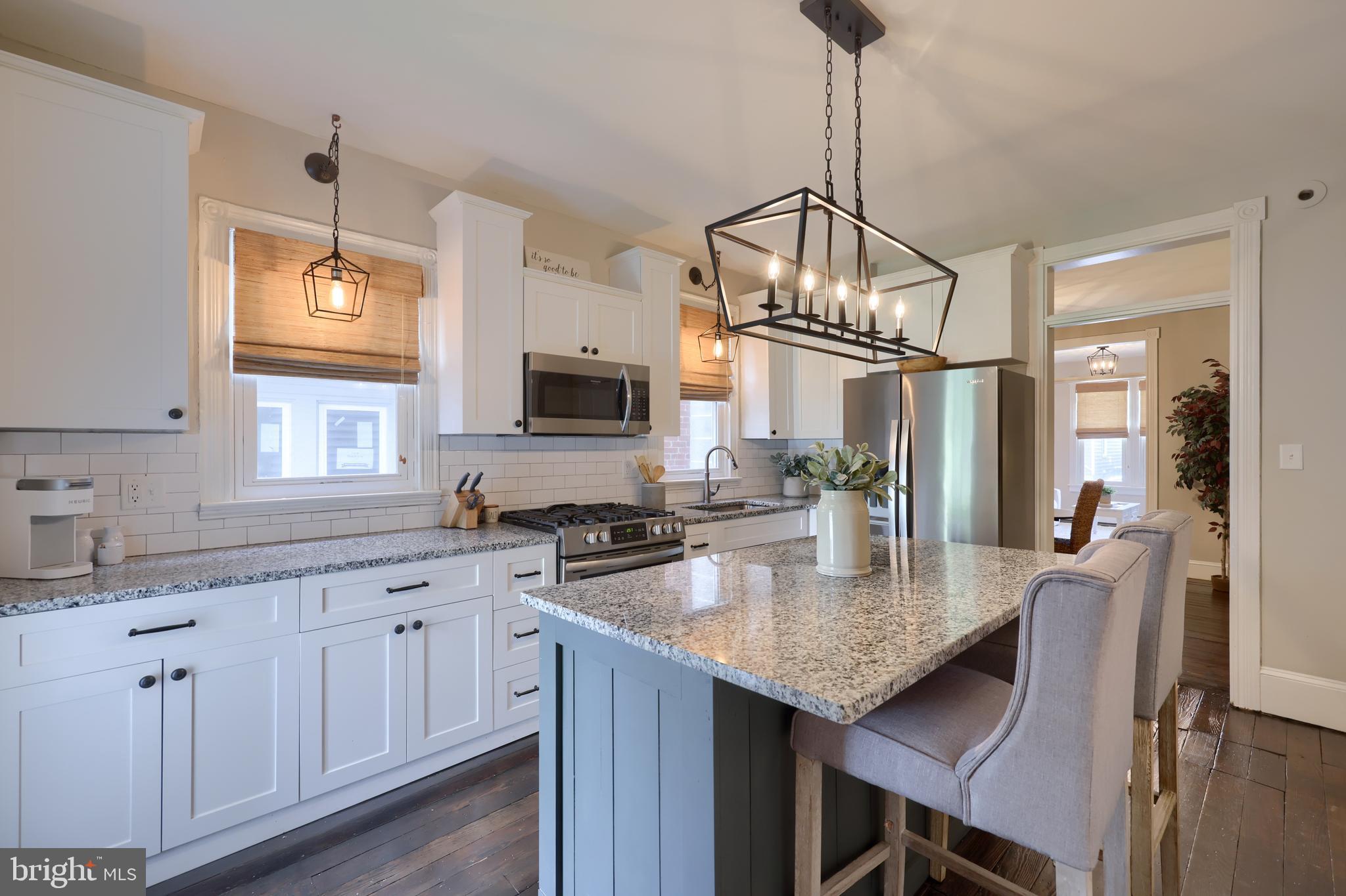 119 South Cedar Street Lititz, PA 17543 - Photo 9 of 22 a kitchen with granite countertop a stove a sink dishwasher a kitchen island with wooden cabinets and floor