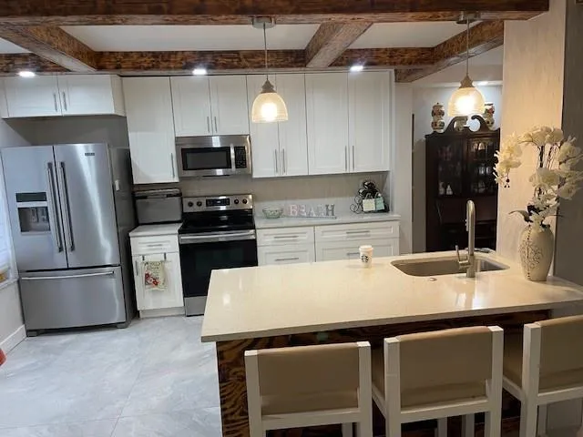 a kitchen with a table chairs refrigerator and microwave