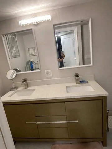 a bathroom with a sink and a mirror