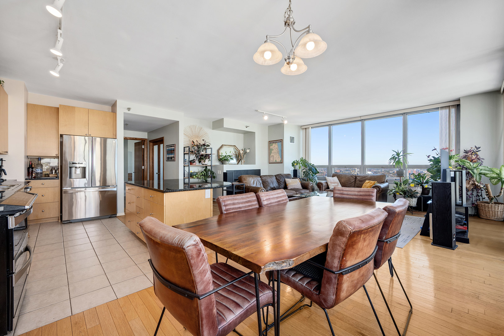 701 South Wells Street, Unit 3006 Chicago, IL 60607 - Photo 11 of 32 a view of a dining room and livingroom with furniture wooden floor a chandelier