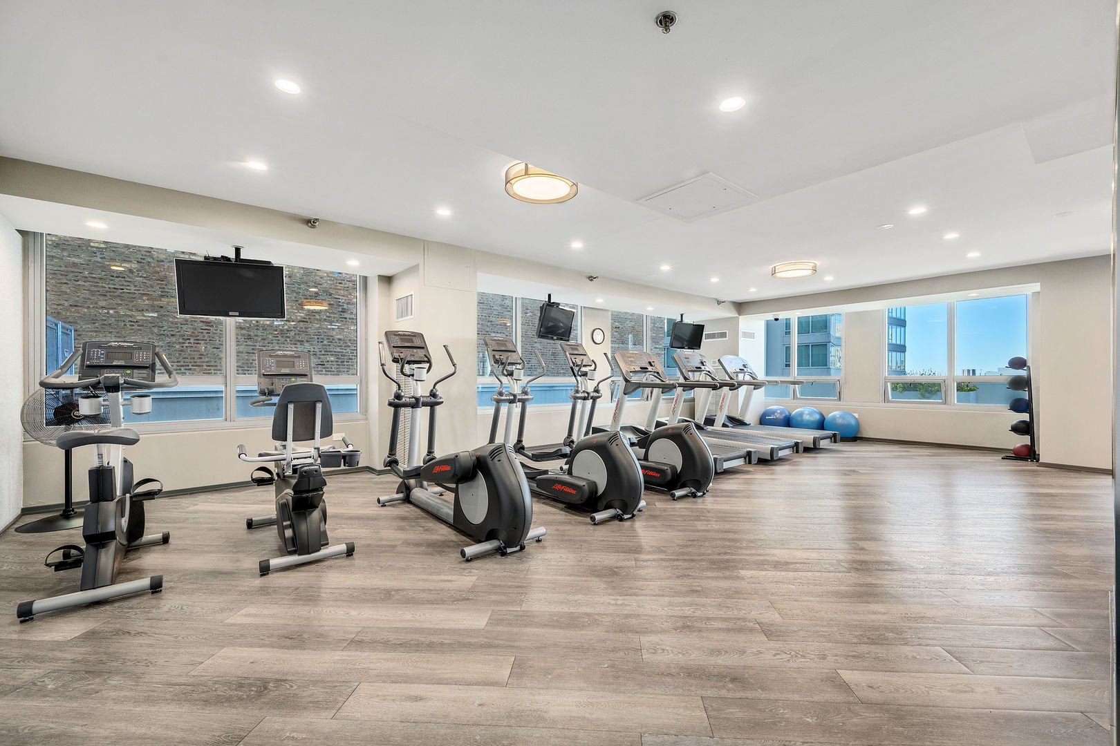 701 South Wells Street, Unit 3006 Chicago, IL 60607 - Photo 25 of 32 a view of a room with gym equipment and a large window