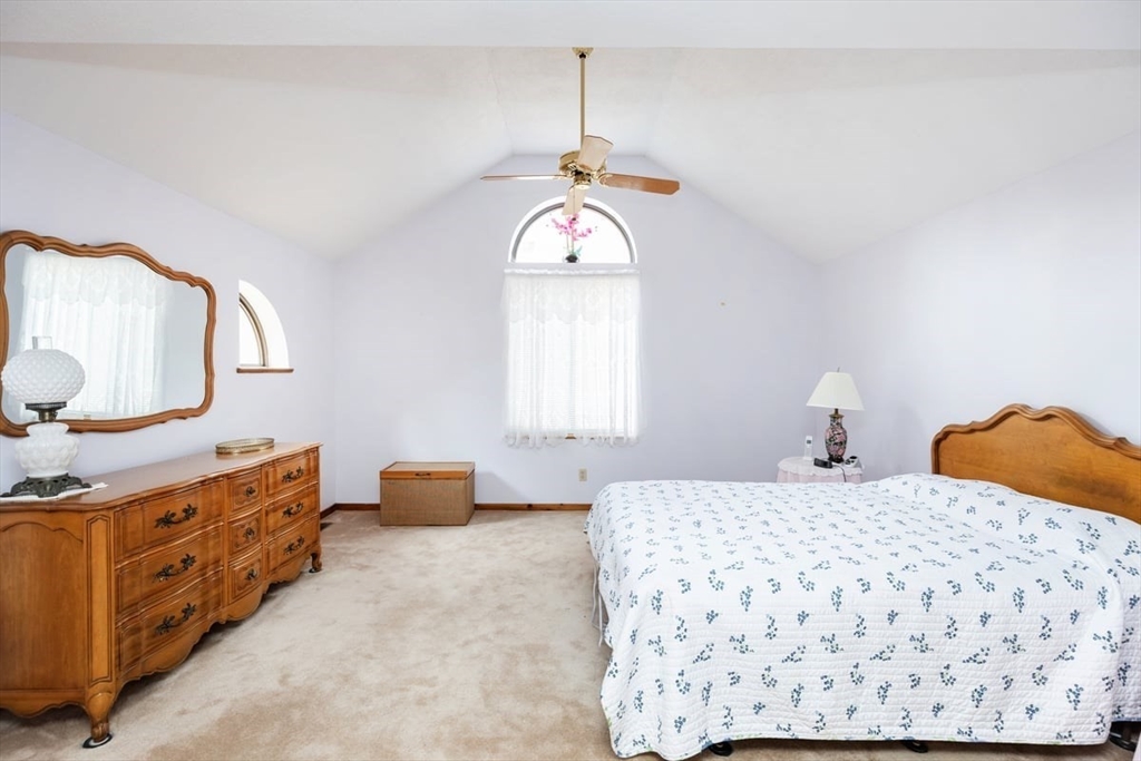 81 Clement Court, Unit 81 Haverhill, MA 01832 - Photo 16 of 36 a bedroom with a bed and dresser with mirror
