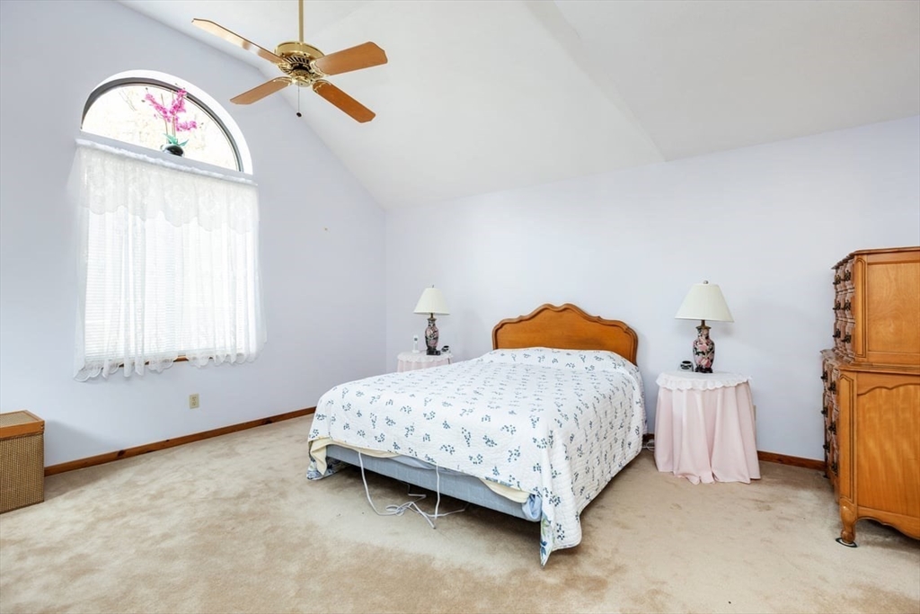 81 Clement Court, Unit 81 Haverhill, MA 01832 - Photo 17 of 36 a bedroom with a bed and a chandelier