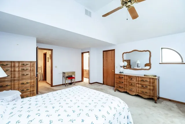 a bedroom with a bed and a dresser in it