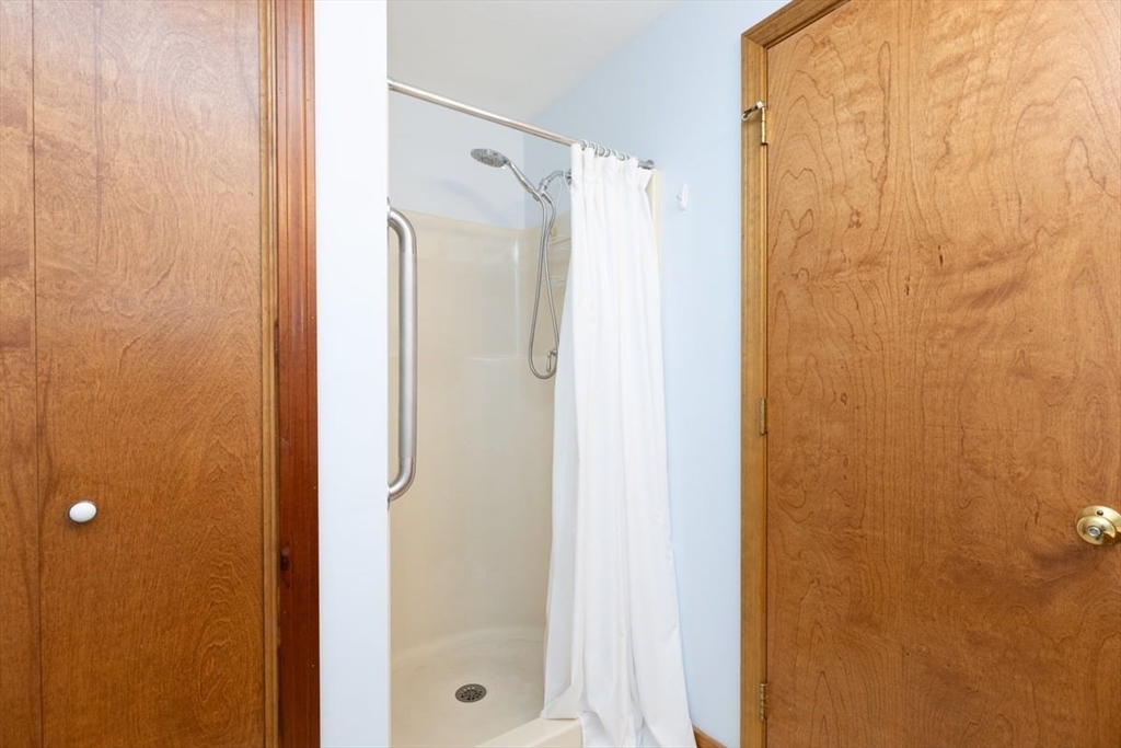 81 Clement Court, Unit 81 Haverhill, MA 01832 - Photo 27 of 36 a bathroom with a shower and a glass door