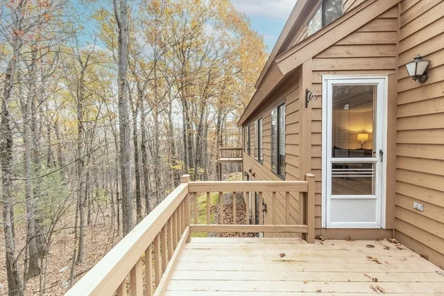 a view of a balcony with wooden floor and fence
