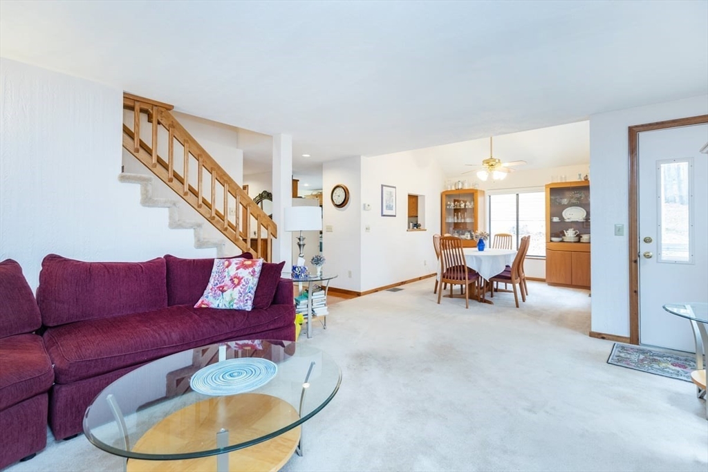 81 Clement Court, Unit 81 Haverhill, MA 01832 - Photo 7 of 36 a living room with furniture and a gym equipment