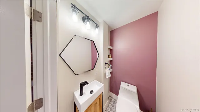 a bathroom with a toilet and a mirror