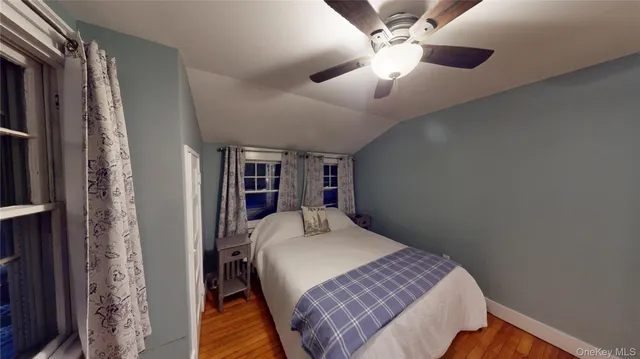 a bedroom with a large bed and a bookshelf