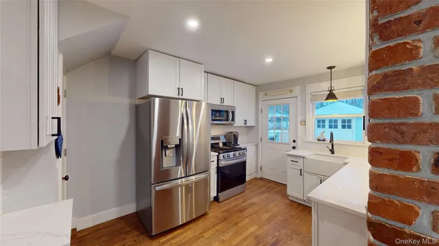 a kitchen with stainless steel appliances a refrigerator sink and stove