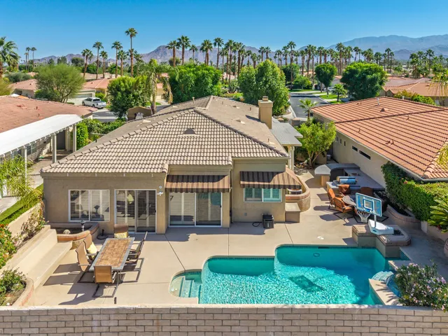 an aerial view of a house with swimming pool garden and patio