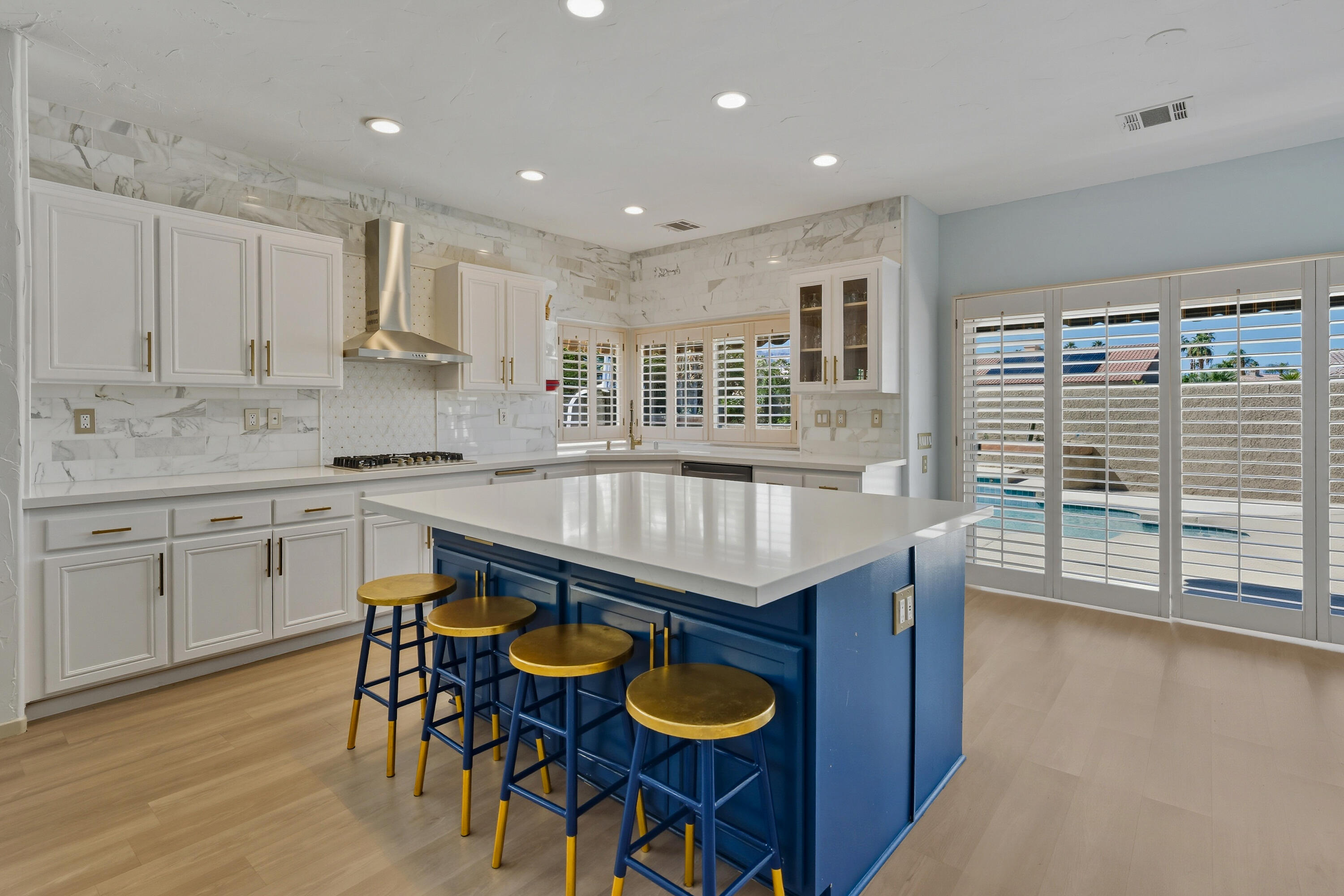 15 Florentina Drive Rancho Mirage, CA 92270 - Photo 12 of 34 a kitchen with granite countertop a stove and white cabinets
