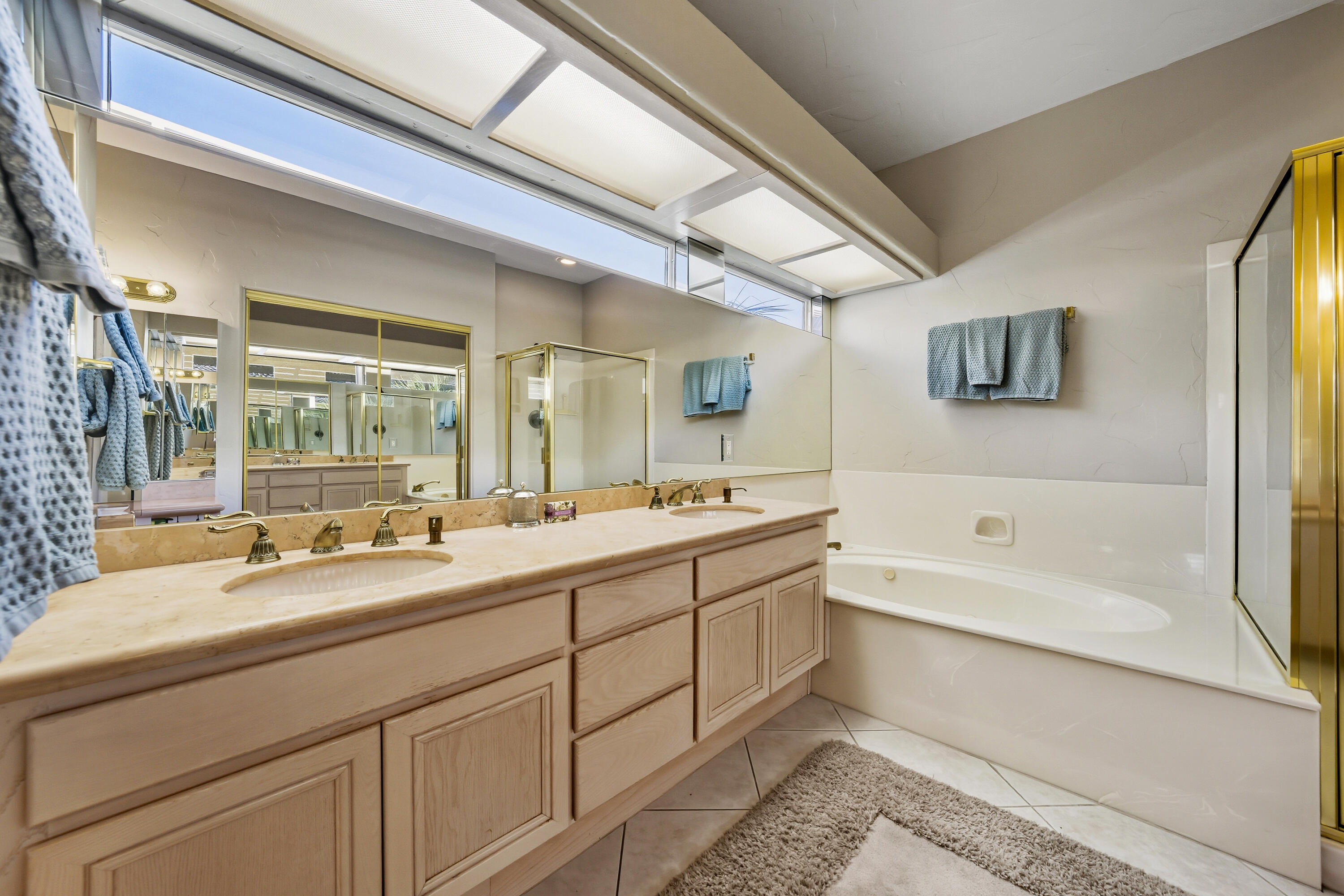 15 Florentina Drive Rancho Mirage, CA 92270 - Photo 17 of 34 a bathroom with a large tub sink and mirror