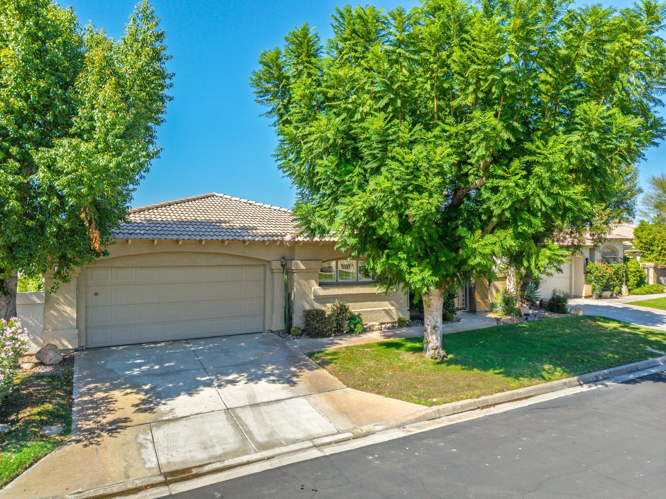 15 Florentina Drive Rancho Mirage, CA 92270 - Photo 2 of 34 a view of a house with a yard plants and a large tree