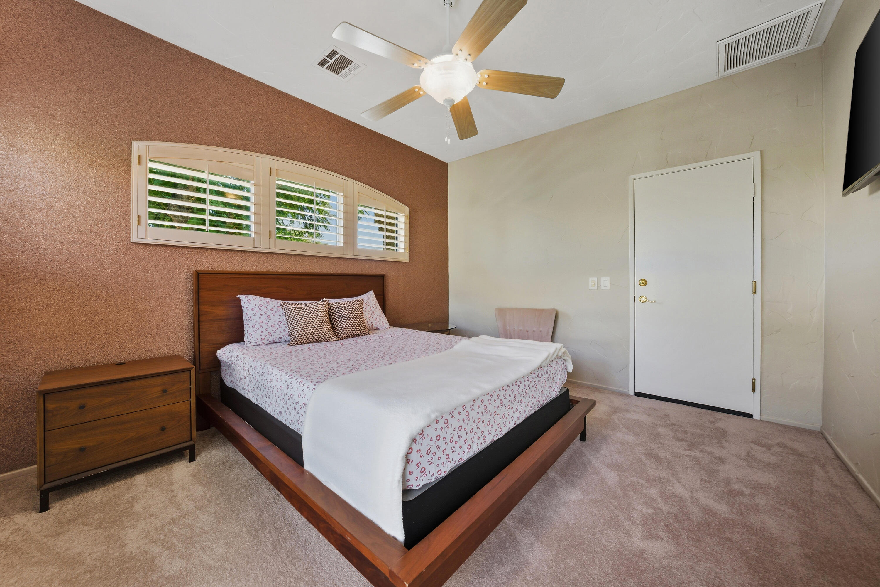 15 Florentina Drive Rancho Mirage, CA 92270 - Photo 23 of 34 a bedroom with a bed and a ceiling fan