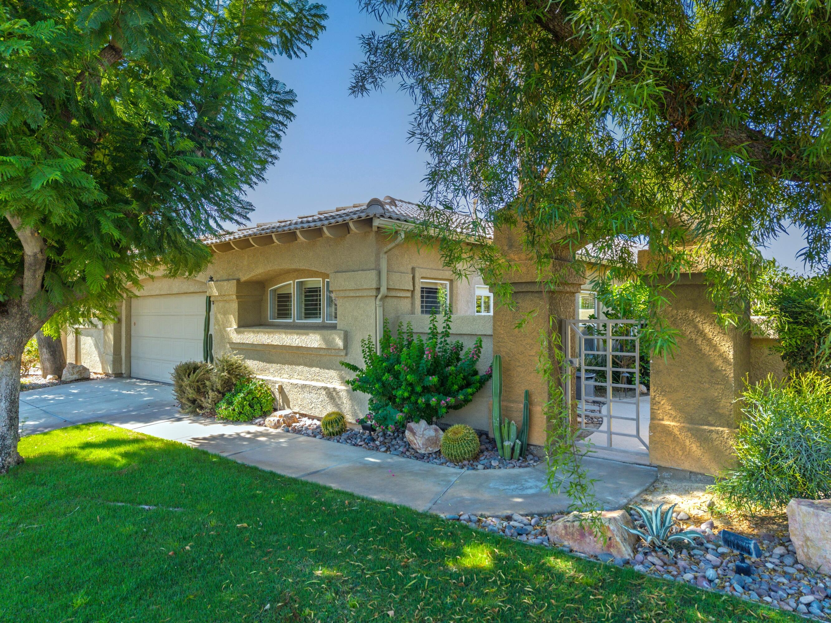 15 Florentina Drive Rancho Mirage, CA 92270 - Photo 3 of 34 a front view of a house with garden