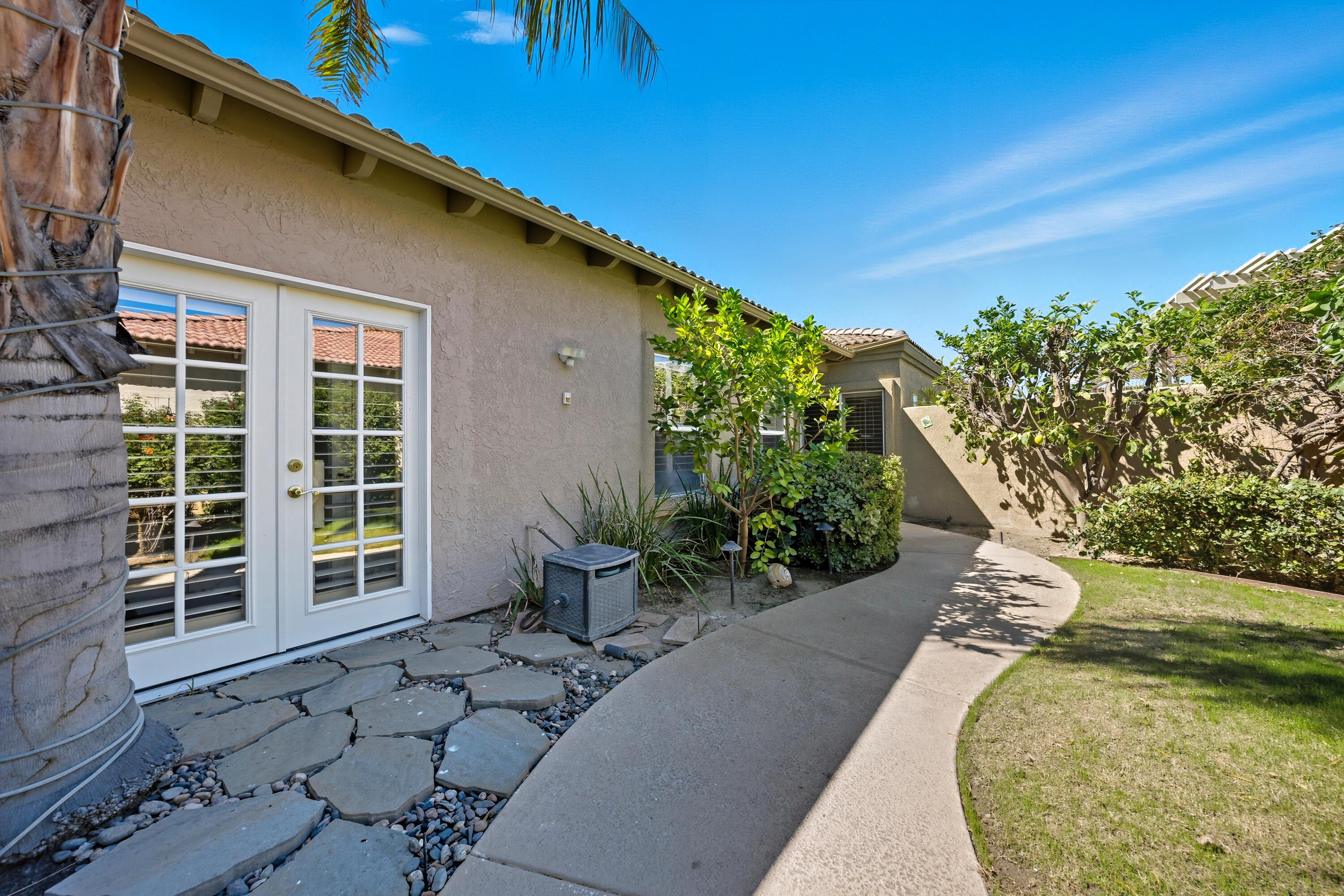 15 Florentina Drive Rancho Mirage, CA 92270 - Photo 4 of 34 a view of a backyard with plants and a patio