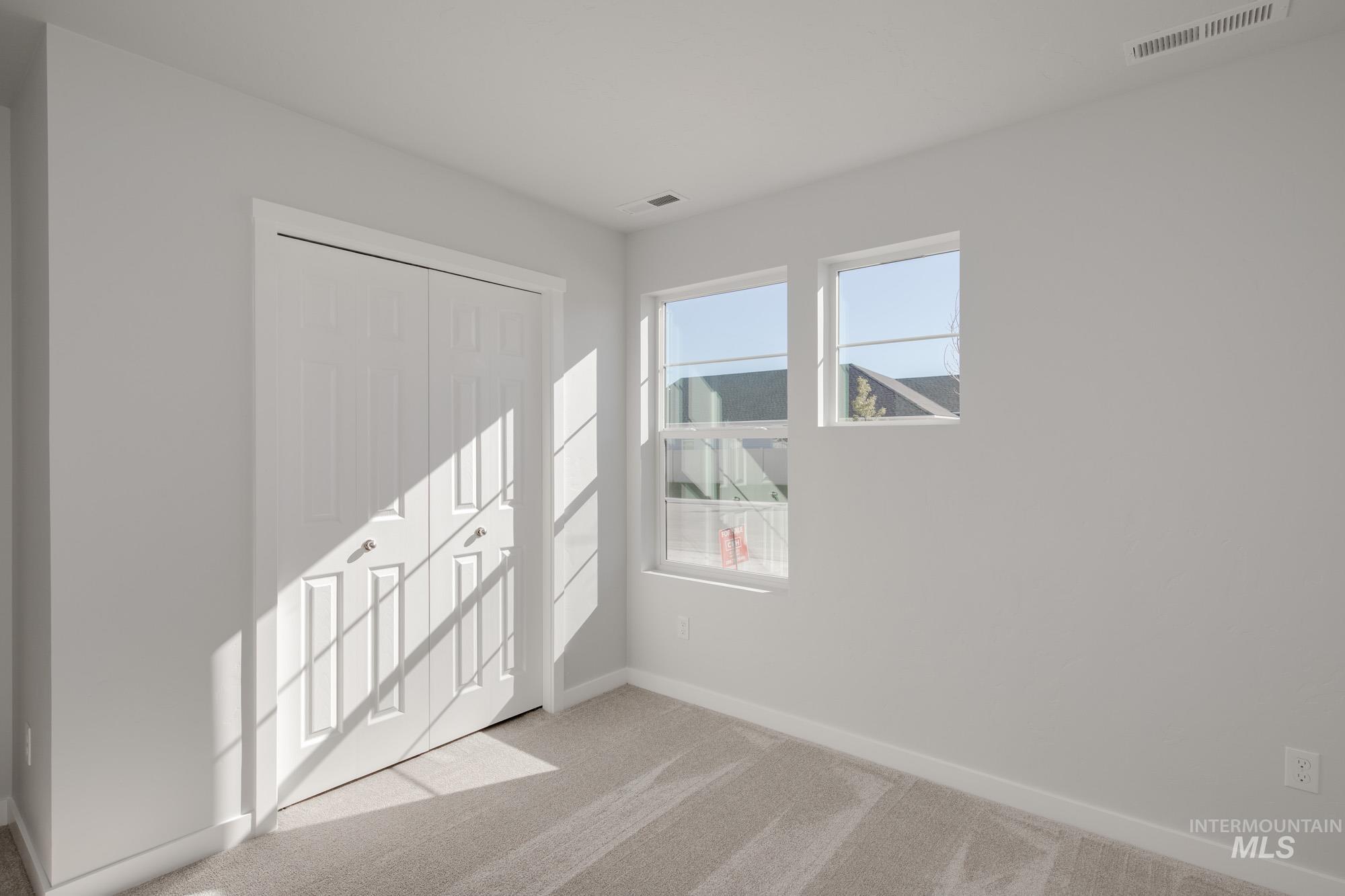 1832 West Unforgettable Street Meridian, ID 83642 - Photo 13 of 22 Unfurnished bedroom with light carpet and a closet