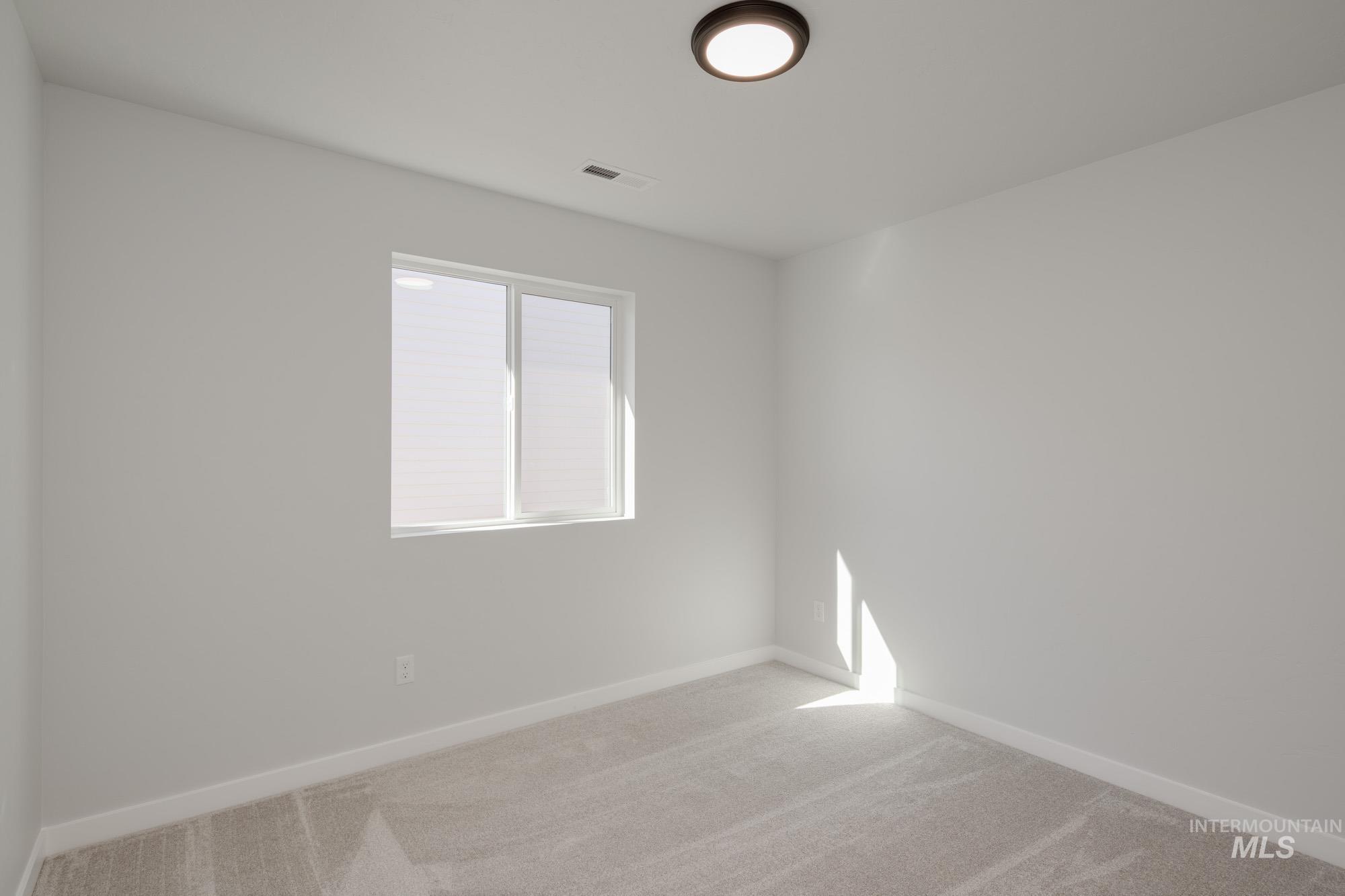 1832 West Unforgettable Street Meridian, ID 83642 - Photo 14 of 22 Carpeted spare room featuring baseboards
