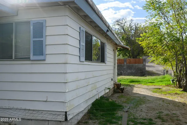 a view of house with backyard