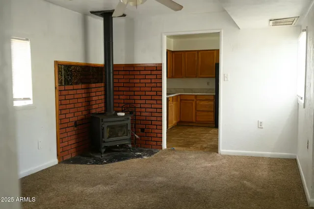 a view of an empty room and fire place