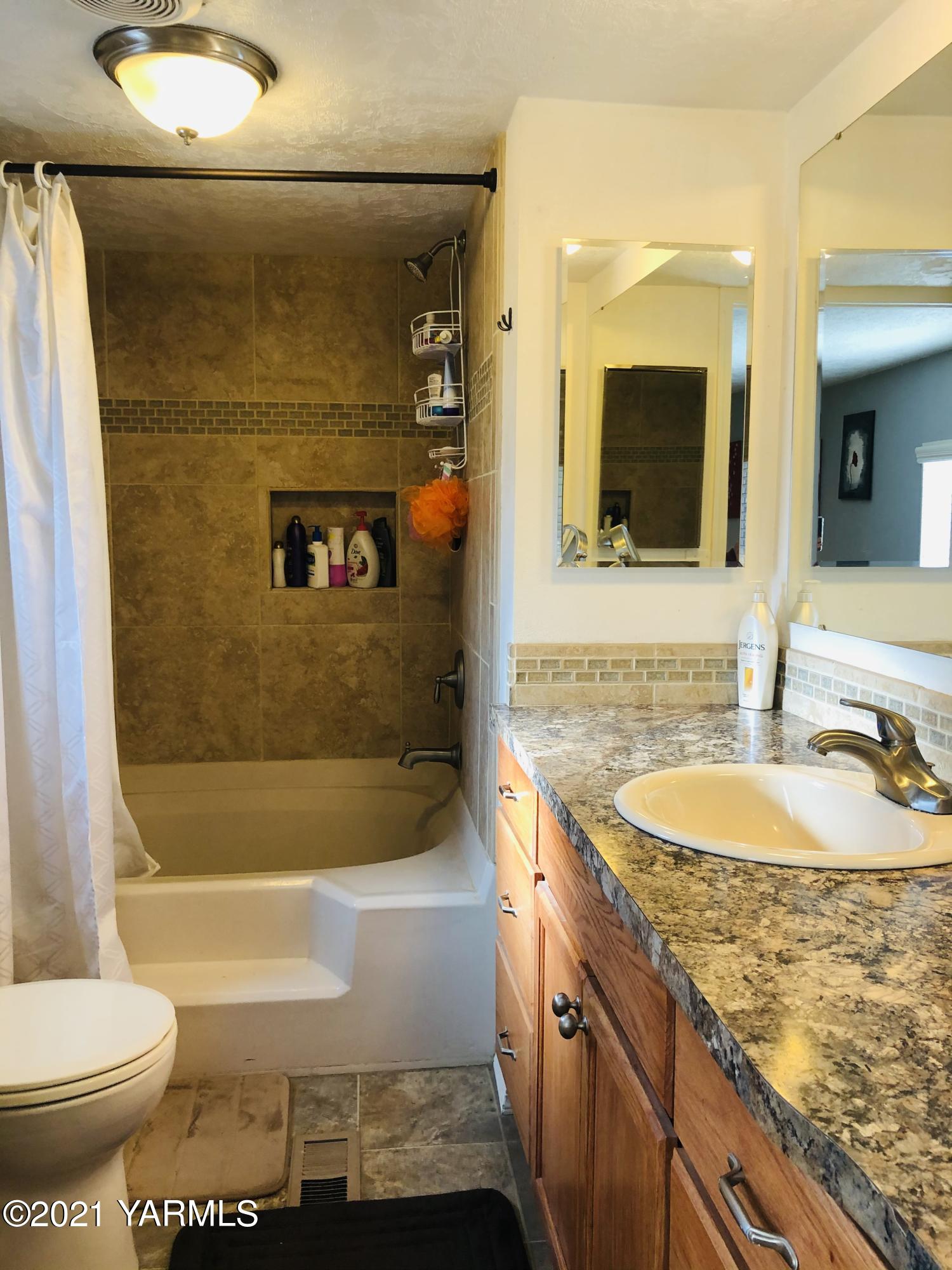 13807 Knox Road Yakima, WA 98908 - Photo 20 of 30 a bathroom with a granite countertop sink toilet and shower