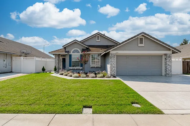 a front view of house with yard patio and fire pit