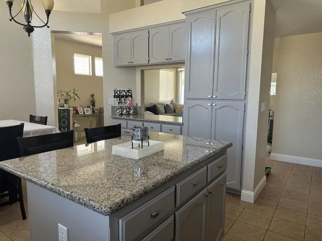 a kitchen with cabinets and chandelier