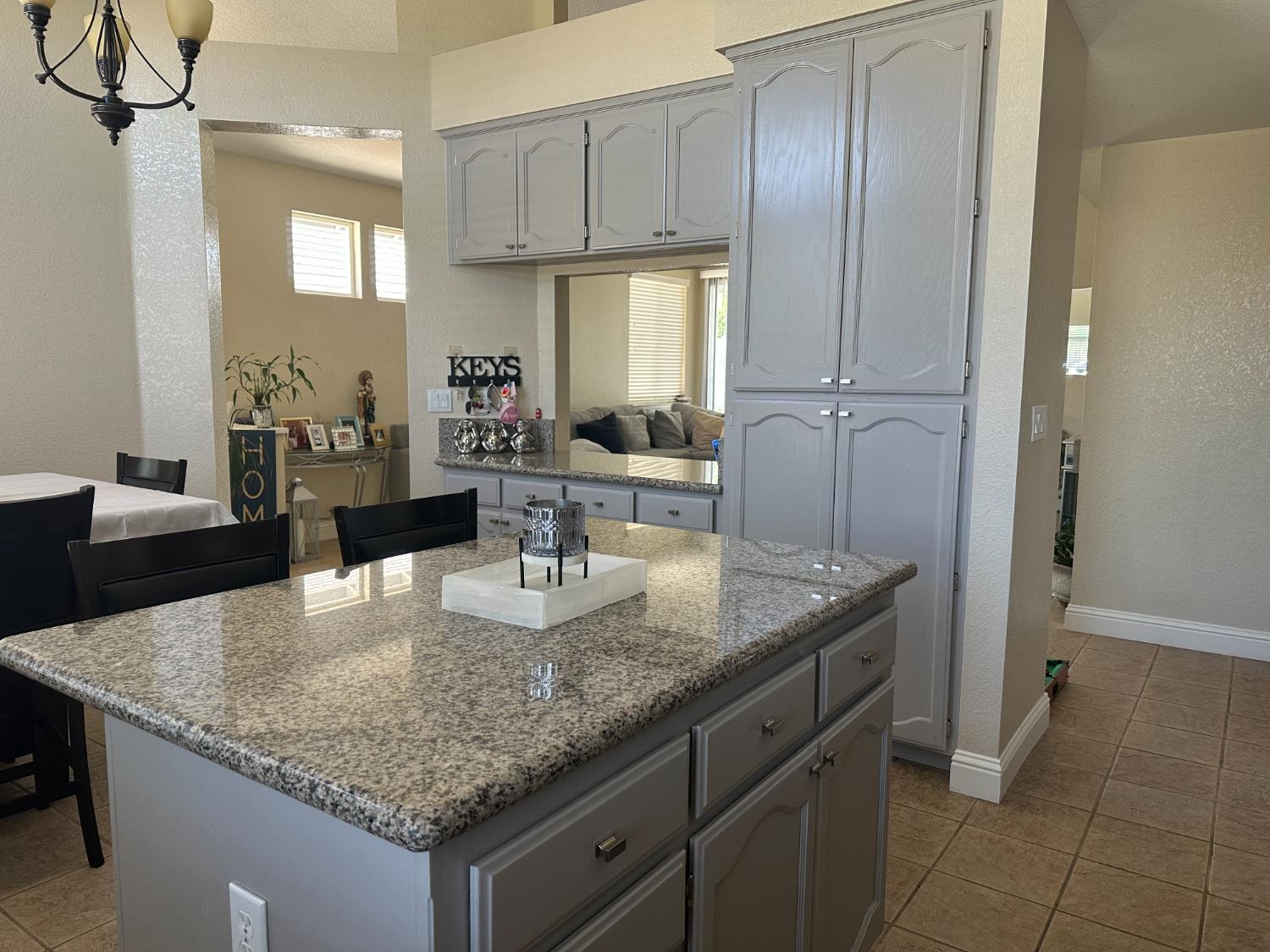 628 Mission Ridge Drive Manteca, CA 95337 - Photo 13 of 27 a kitchen with cabinets and chandelier