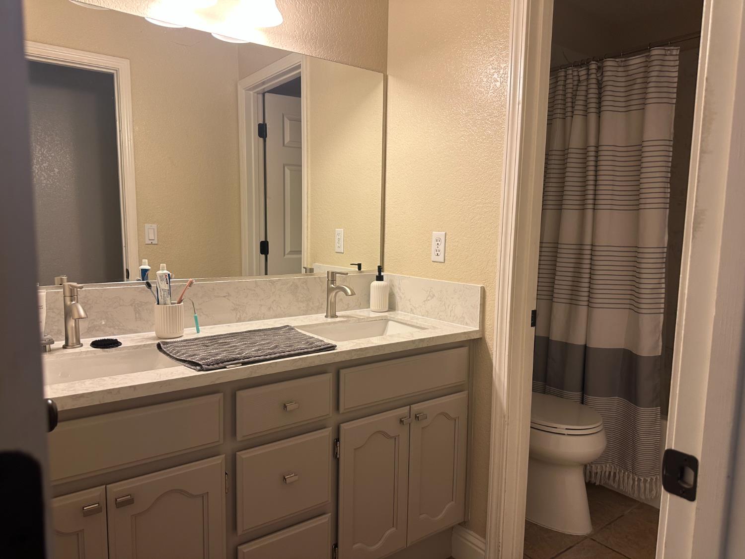 628 Mission Ridge Drive Manteca, CA 95337 - Photo 18 of 27 a bathroom with a granite countertop sink toilet and shower