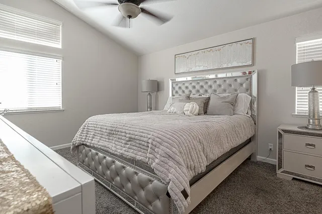 a bedroom with a bed and window