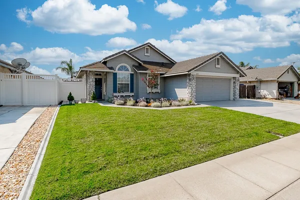 a front view of house with yard and green space