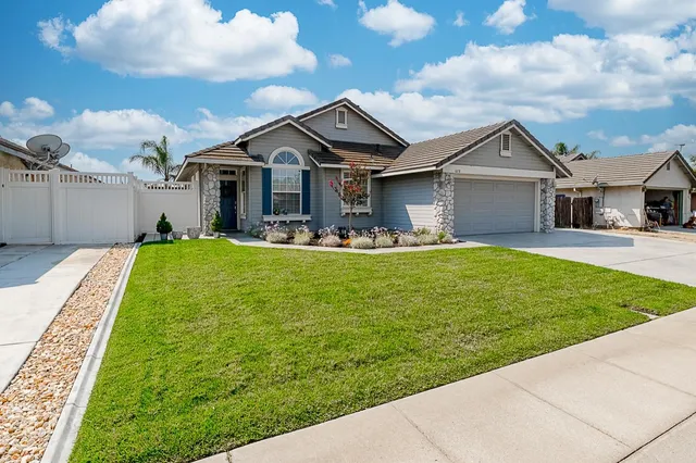 a front view of house with yard and green space