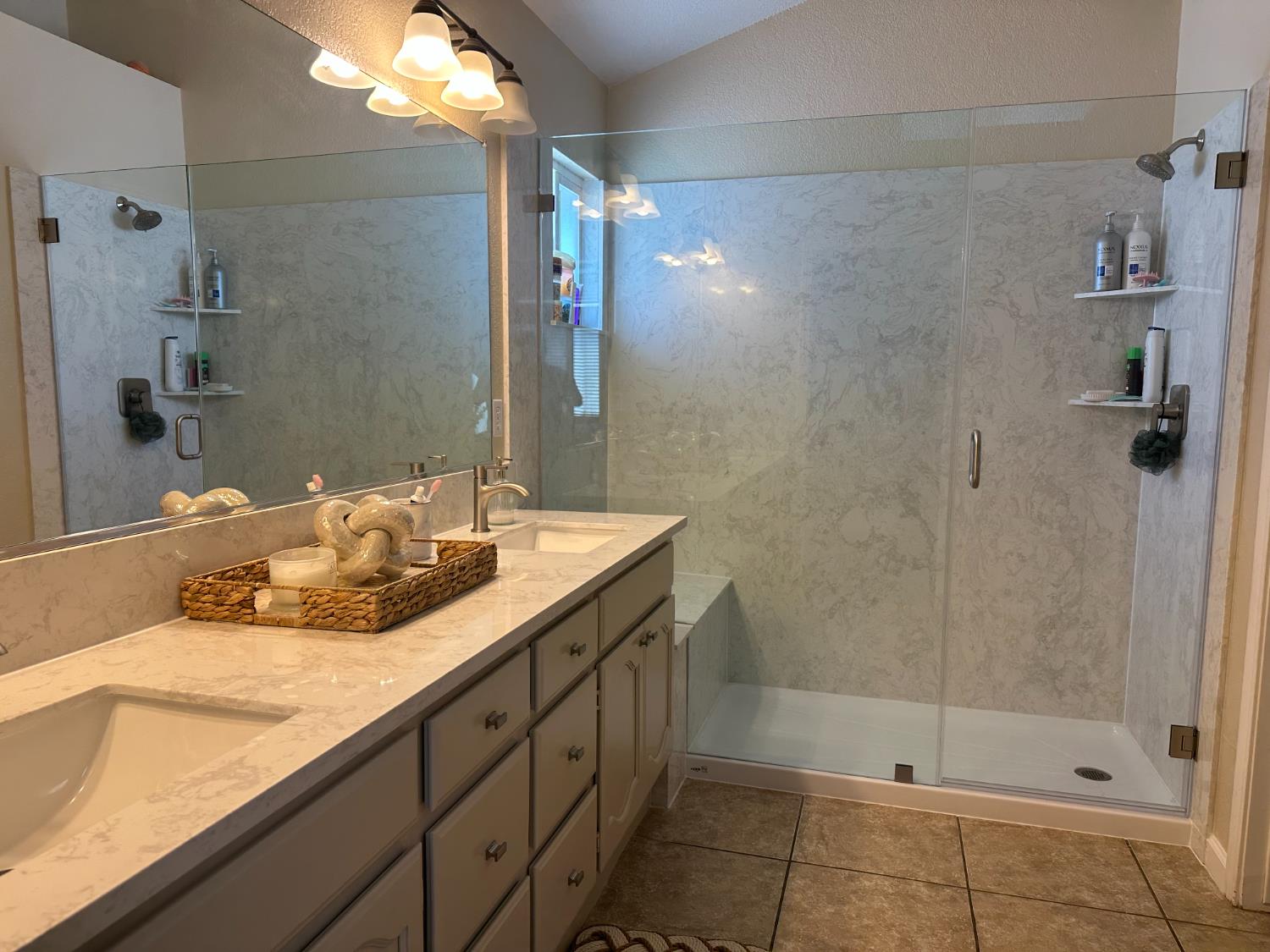 628 Mission Ridge Drive Manteca, CA 95337 - Photo 21 of 27 a bathroom with a granite countertop sink a shower and a mirror