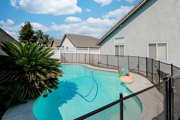 a view of a backyard with plants and a patio