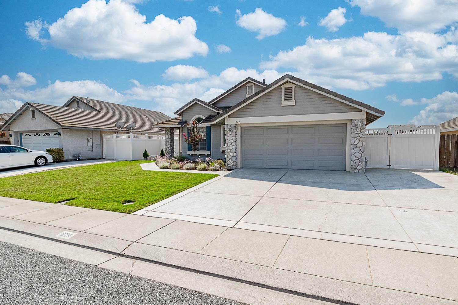 628 Mission Ridge Drive Manteca, CA 95337 - Photo 3 of 27 a front view of a house with a yard and garage
