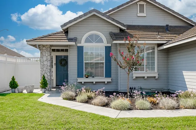 a front view of a house with garden