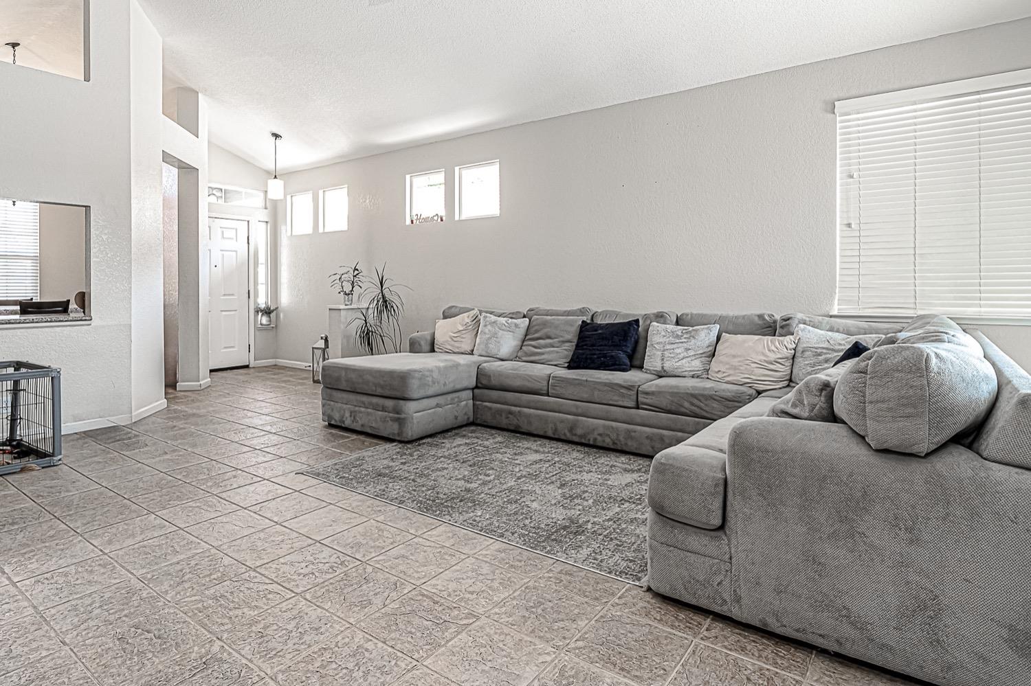 628 Mission Ridge Drive Manteca, CA 95337 - Photo 8 of 27 a living room with furniture and a flat screen tv