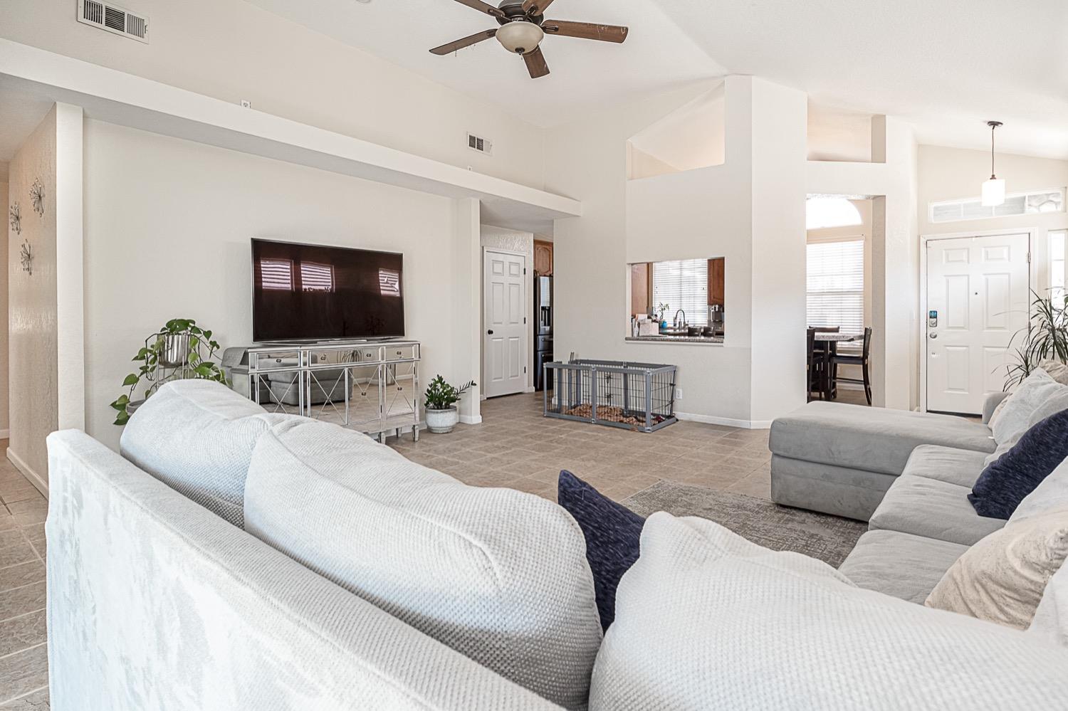628 Mission Ridge Drive Manteca, CA 95337 - Photo 10 of 27 a living room with furniture and a flat screen tv